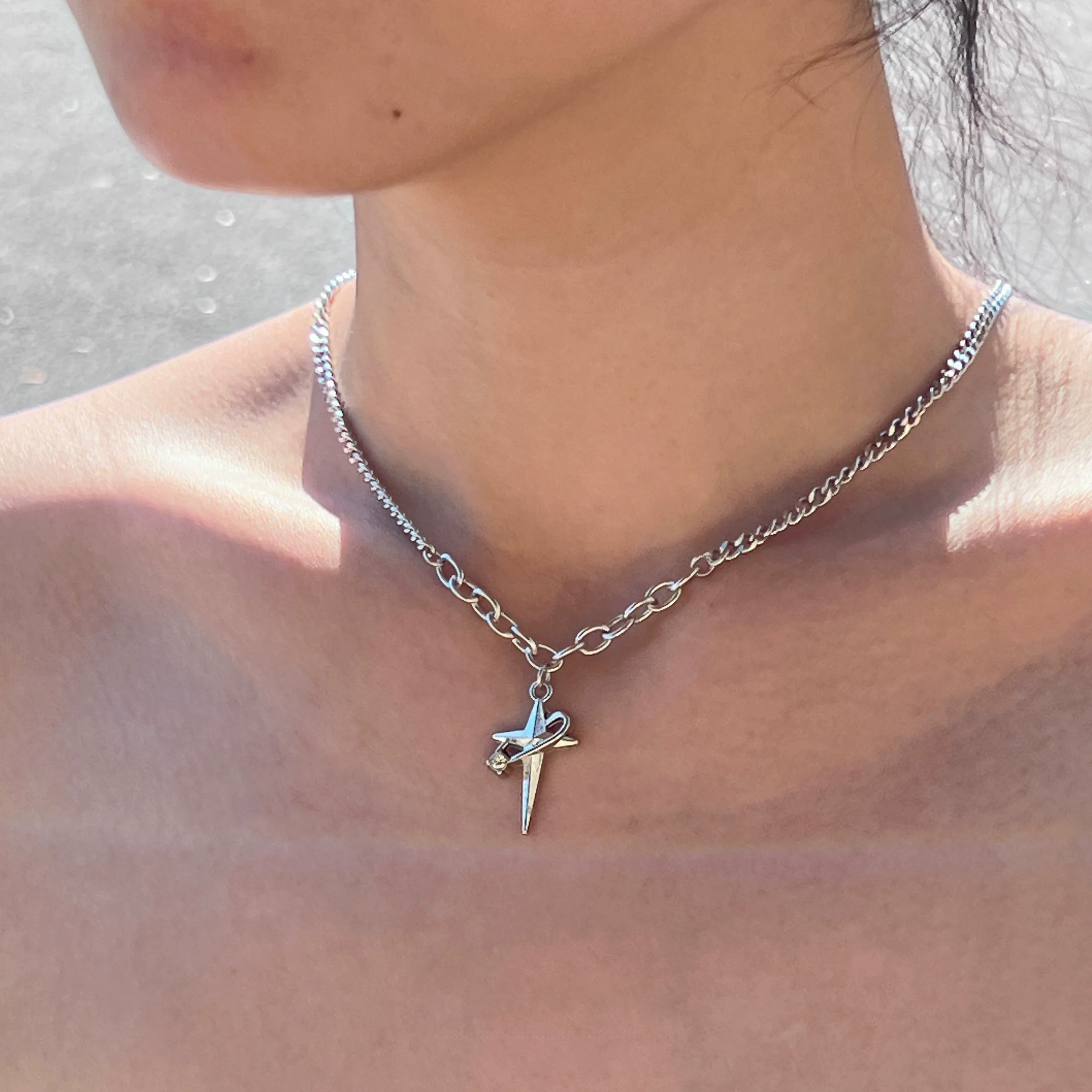 Sanhoostudio’s star cross wrap titanium necklace wraps gothic motifs into layered titanium design—sturdy, stylish, and ideal for dark-luxe streetwear and layered accessorizing.