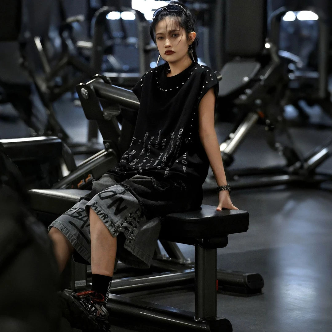 Sanhoostudio sleeveless T-shirt featuring distressed detailing, red spray-print artwork, and a relaxed oversized fit. Designed for summer streetwear styling with breathable comfort and a bold urban aesthetic.