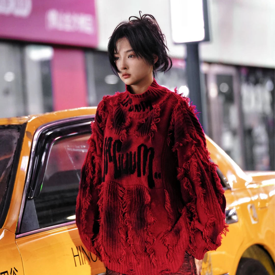 Street rebellion meets knit precision — this high-density graffiti sweater with distressed neck and paint-splash detail reflects SanhooStudio’s high-street chaos and raw design soul.