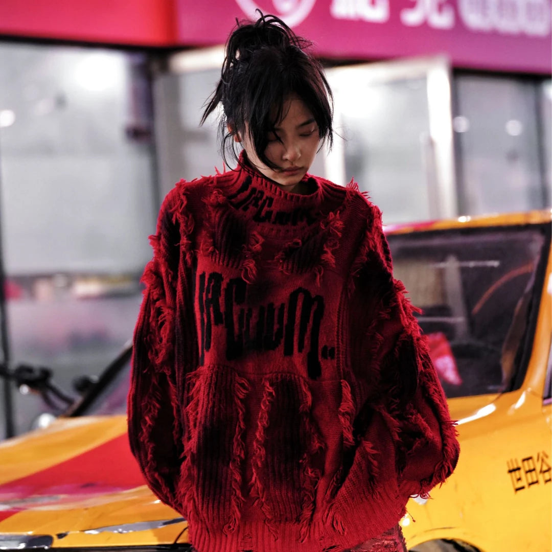 Street rebellion meets knit precision — this high-density graffiti sweater with distressed neck and paint-splash detail reflects SanhooStudio’s high-street chaos and raw design soul.
