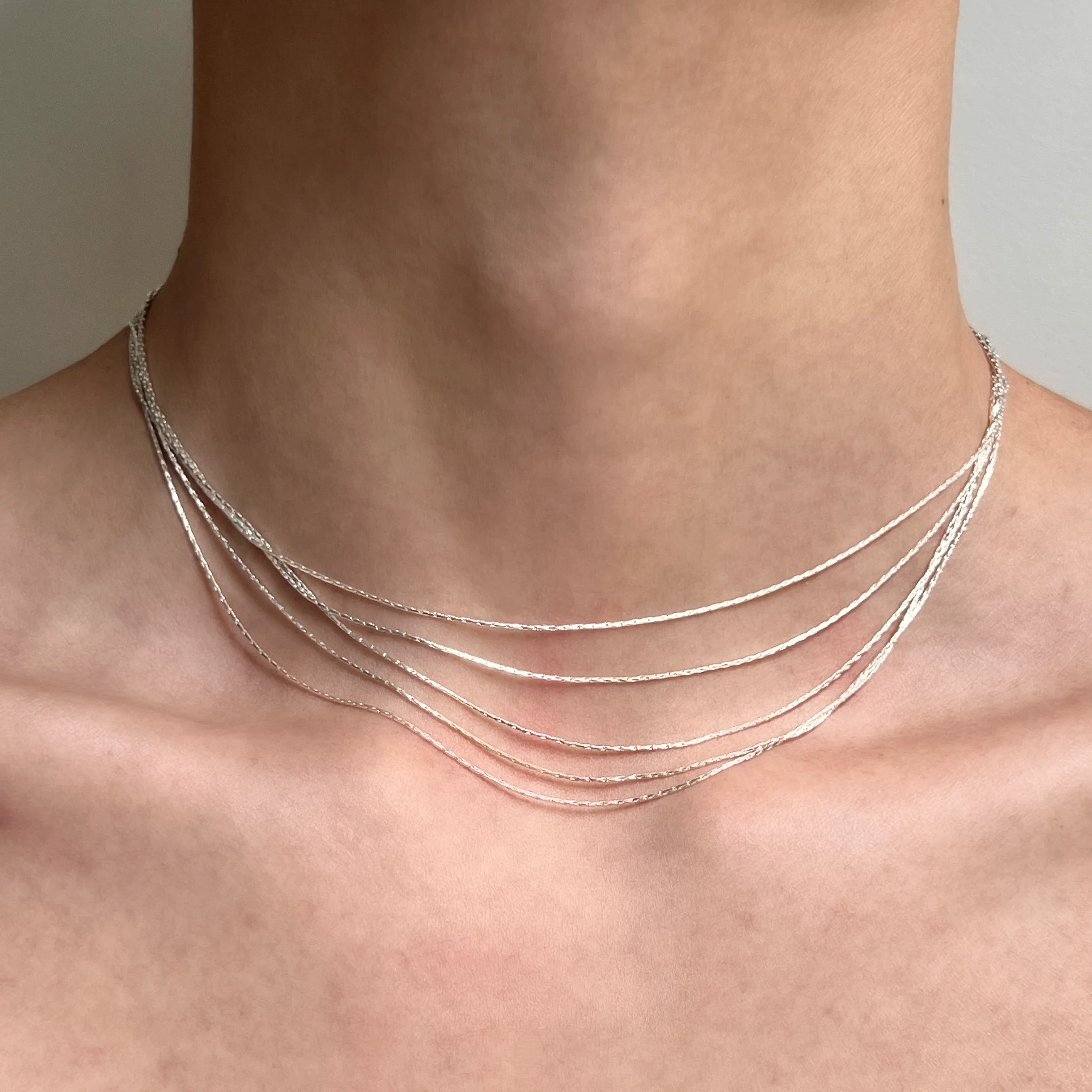 Sanhoostudio’s silver multi-layer thin chain necklace delivers delicate sparkle and romantic bling—perfect for layering, special occasions, and elevating everyday outfits with refined shine.