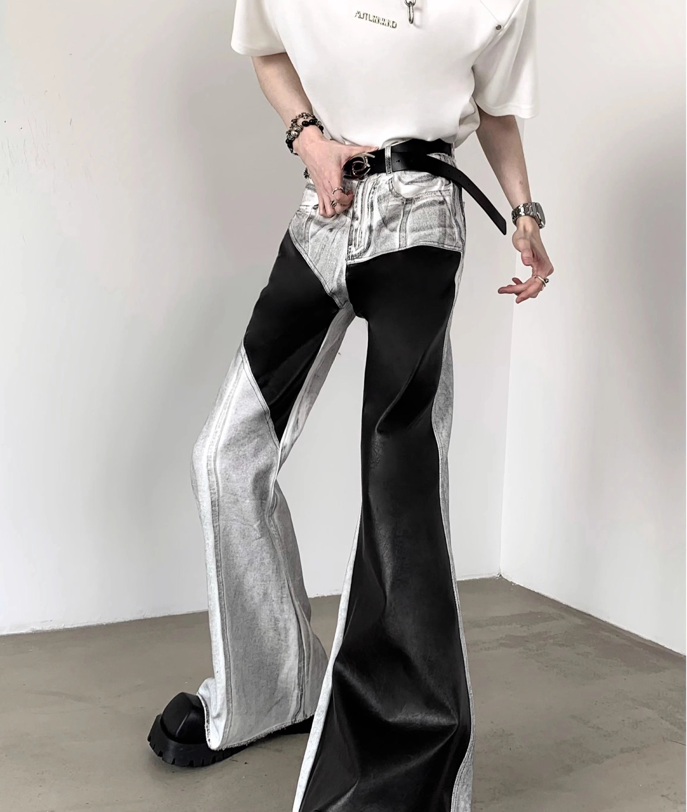 The Sanhoostudio distressed off-white jeans combine premium leather patchwork with a subtle flared cut. Their faded finish adds a rugged vintage vibe, while the unique detailing enhances versatility, making them a must-have for bold, high-fashion urban wardrobes.