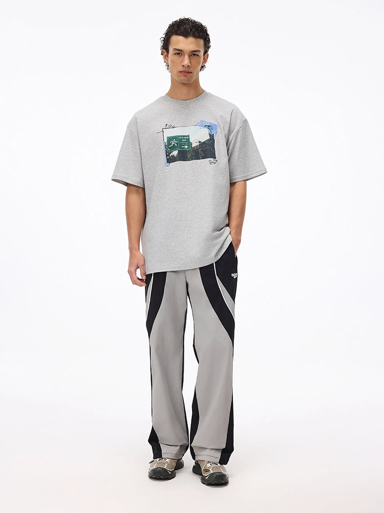 These vintage-inspired lightweight sport pants from Sanhoostudio feature a water-resistant finish and relaxed fit. Perfect for casual outings or streetwear looks with a retro athletic twist.