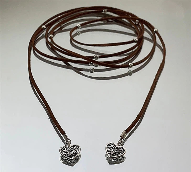 Express effortless Bohemian charm with Sanhoostudio’s silver heart wrap necklace. The long leather cord design combines vintage texture with modern simplicity.