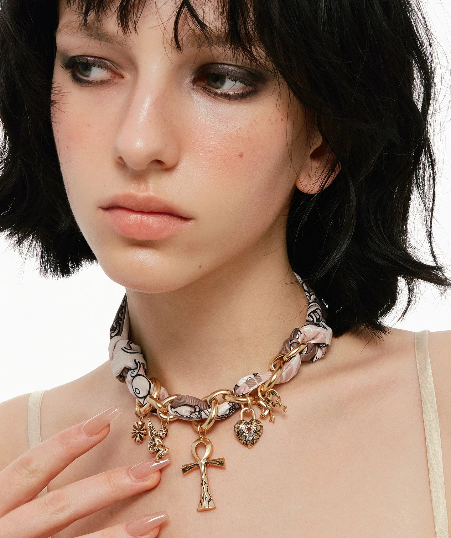 A bold blend of textures — Sanhoostudio’s silk scarf Ankh necklace brings soft femininity and edgy charm into one elegant design.