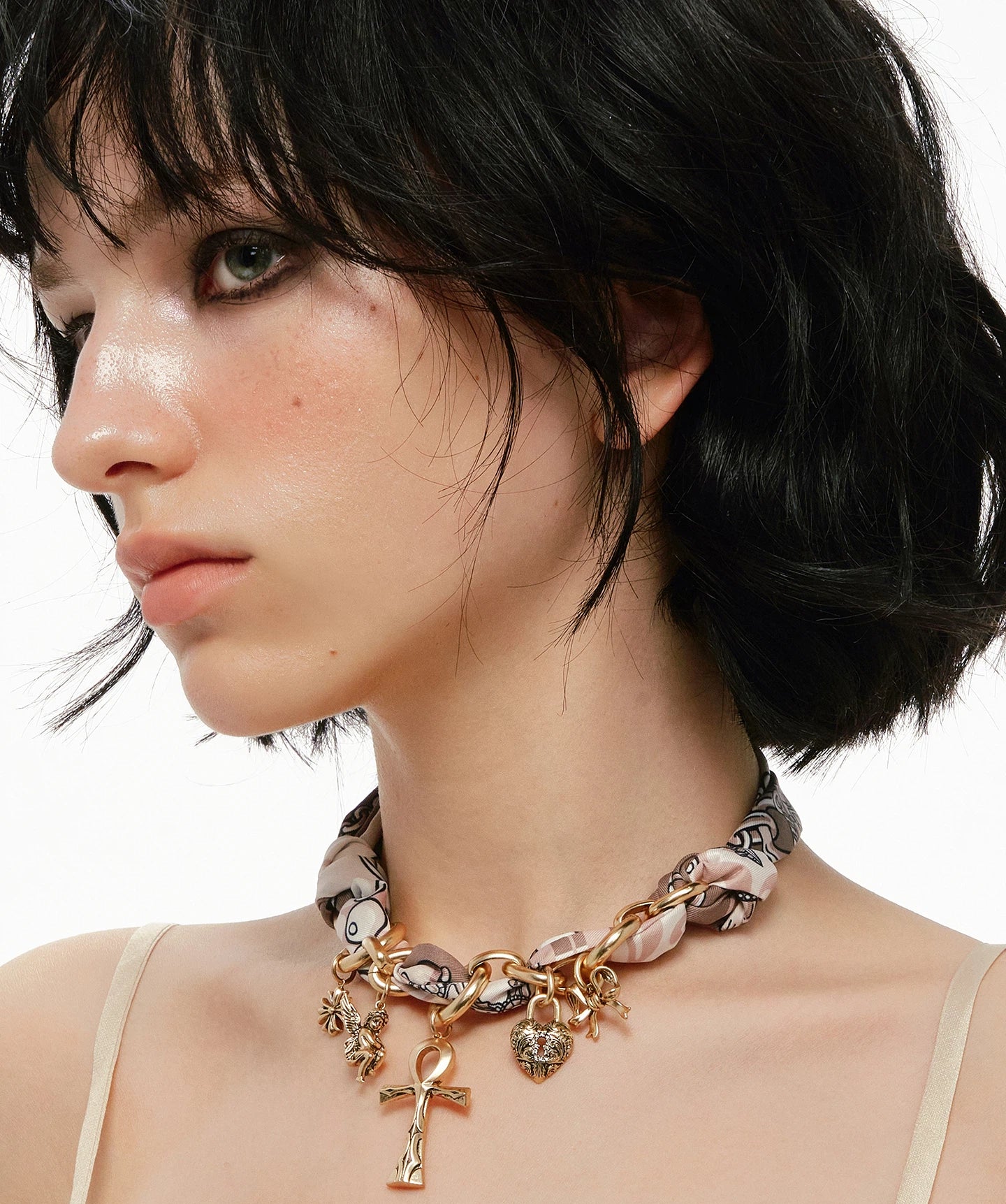 A bold blend of textures — Sanhoostudio’s silk scarf Ankh necklace brings soft femininity and edgy charm into one elegant design.