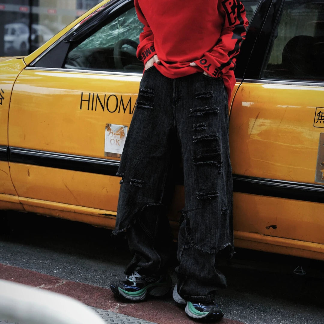 Two-layer distressed cargo pants featuring frayed edges, hip-hop street detailing, and a wide-leg silhouette with strong attitude.