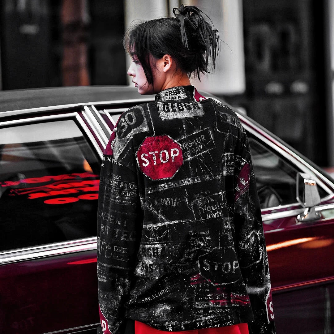 Sanhoostudio oversized graffiti shirt crafted from 100% nylon. Lightweight yet bold, featuring full graffiti print, sharp pointed collar, and relaxed hip-hop street silhouette for unisex styling.