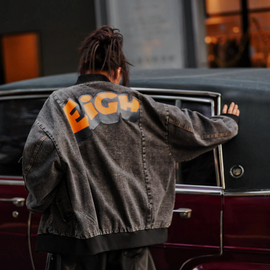Sanhoostudio washed denim varsity jacket featuring contrast paneling and relaxed fit. A timeless unisex jacket for everyday streetwear layering.