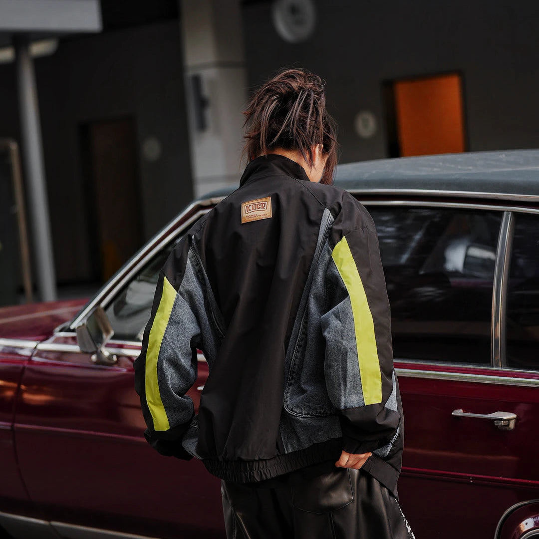 Sanhoostudio washed denim varsity jacket featuring contrast paneling and relaxed fit. A timeless unisex jacket for everyday streetwear layering.