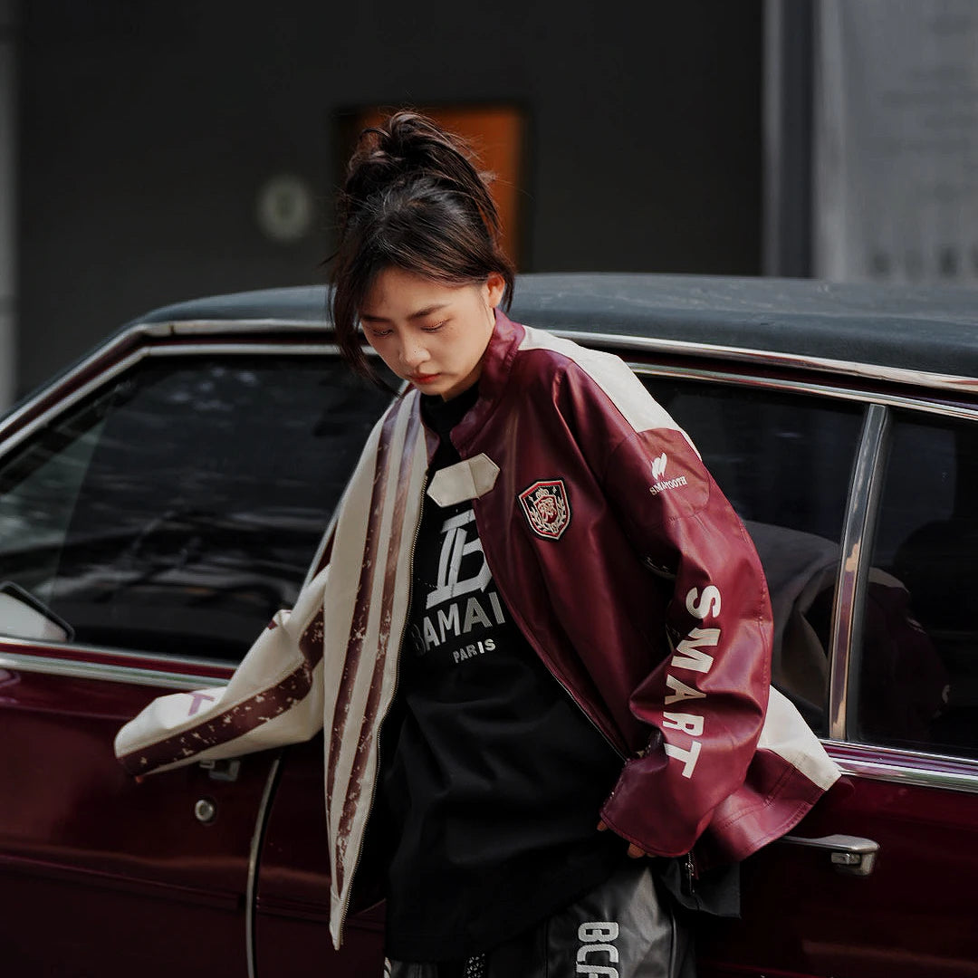 Sanhoostudio washed denim varsity jacket featuring contrast paneling and relaxed fit. A timeless unisex jacket for everyday streetwear layering.