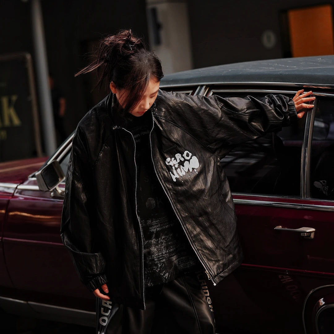 Sanhoostudio washed denim varsity jacket featuring contrast paneling and relaxed fit. A timeless unisex jacket for everyday streetwear layering.