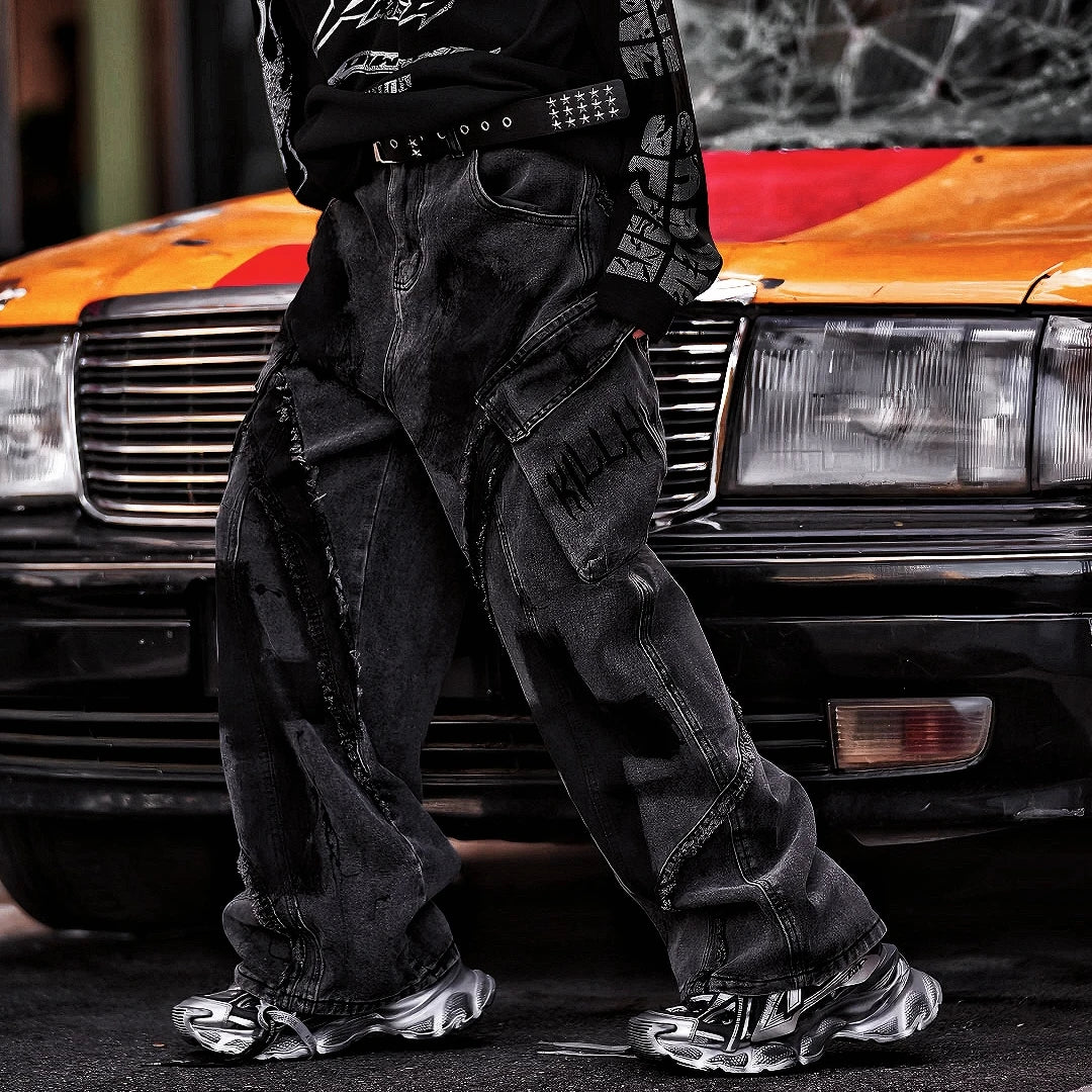 Sanhoostudio heavyweight denim featuring embroidery, graffiti artwork, and washed distressed finish. Designed with patchwork construction for bold unisex streetwear styling.