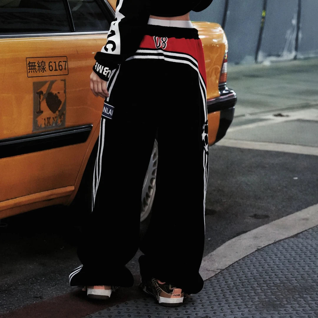 Sanhoostudio heavyweight sweatpants featuring fleece lining and printed details. Designed for unisex comfort and warm streetwear styling in fall and winter.