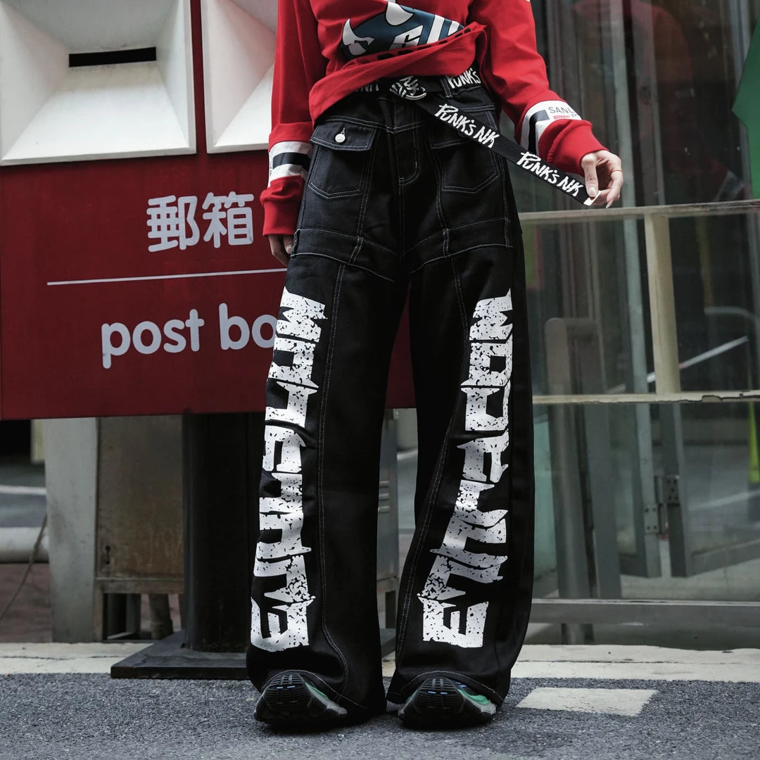 Sanhoostudio denim pants featuring scythe-cut silhouette and letter print design for modern streetwear styling.