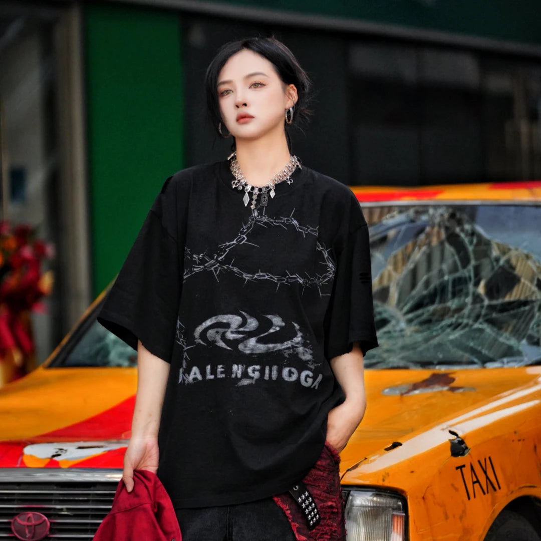 Sanhoostudio short sleeve T-shirt featuring patchwork construction and graphic print design with a relaxed fit silhouette. Designed for modern streetwear styling with comfort, versatility, and everyday wear appeal.