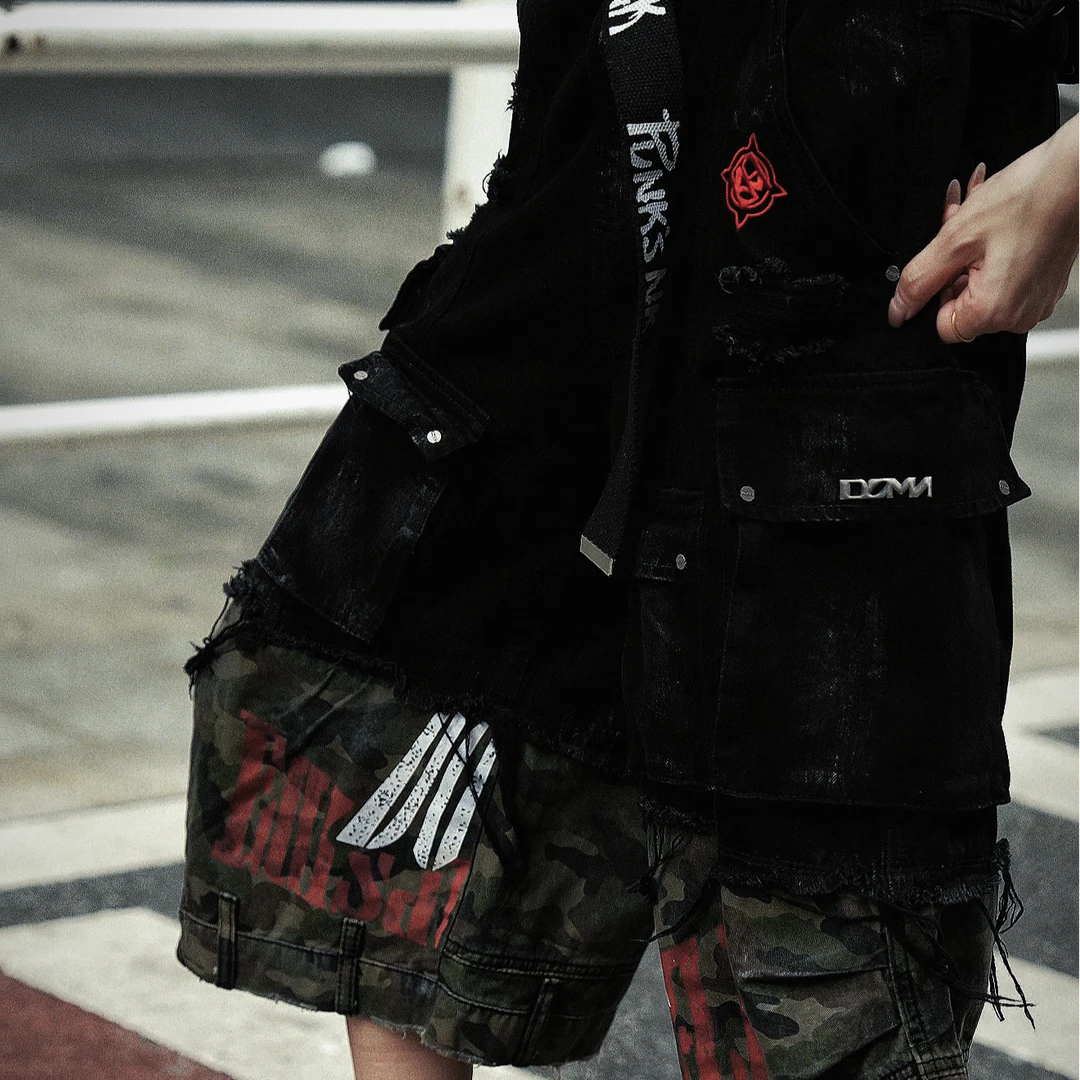 Sanhoostudio denim cargo shorts featuring camouflage patchwork design, multi-pocket construction, and wide leg silhouette. Perfect for summer streetwear styling with breathable comfort, functionality, and versatile daily wear.