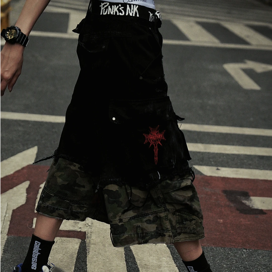 Sanhoostudio denim cargo shorts featuring camouflage patchwork design, multi-pocket construction, and wide leg silhouette. Perfect for summer streetwear styling with breathable comfort, functionality, and versatile daily wear.