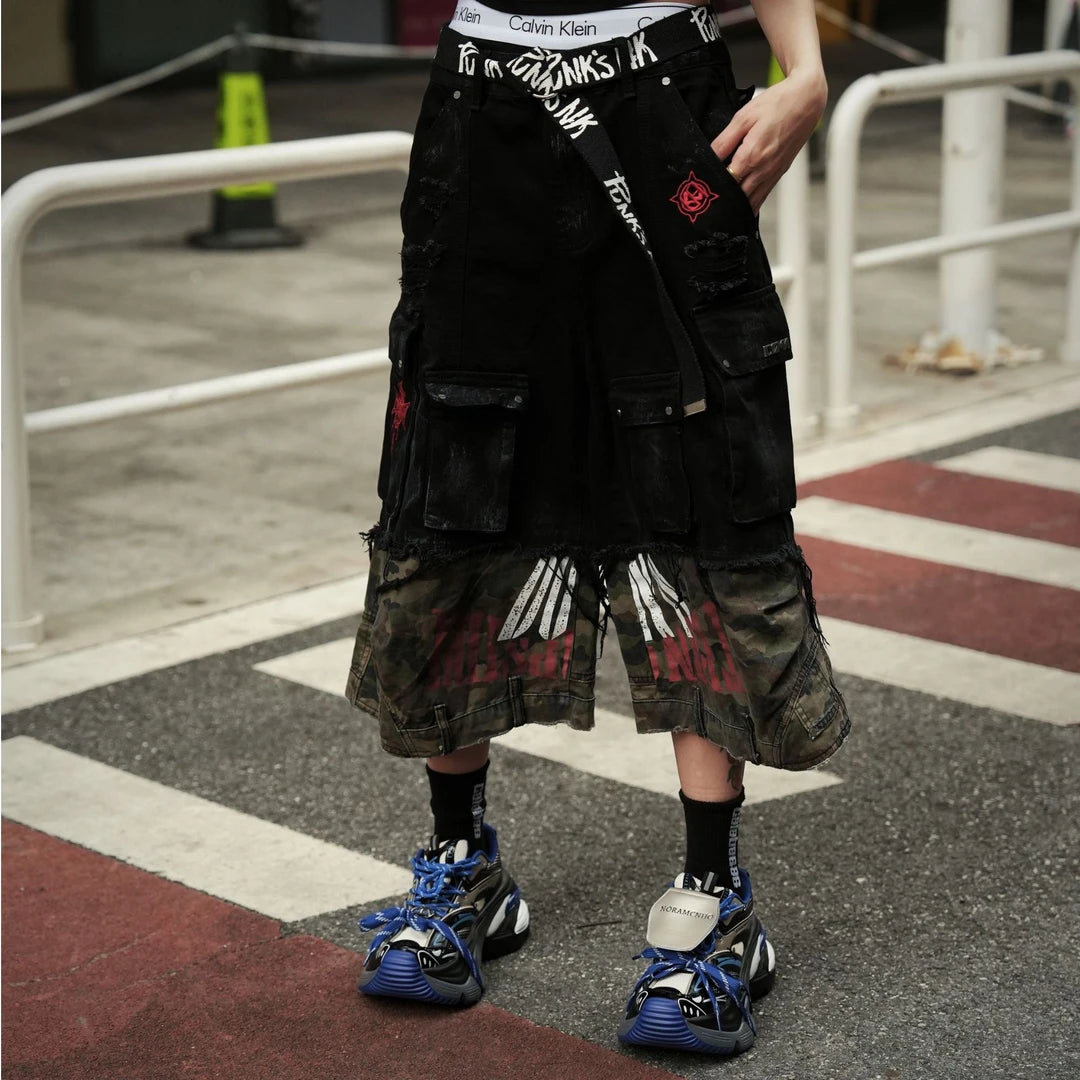 Sanhoostudio denim cargo shorts featuring camouflage patchwork design, multi-pocket construction, and wide leg silhouette. Perfect for summer streetwear styling with breathable comfort, functionality, and versatile daily wear.