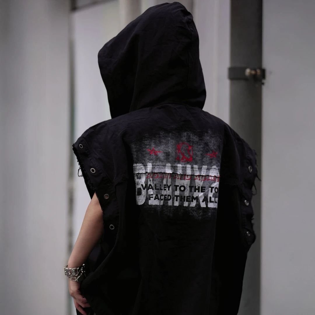Sanhoostudio hooded vest featuring distressed finish, printed graphics, and sleeveless construction. Designed for layering in streetwear outfits, offering lightweight comfort, flexibility, and a strong modern utility aesthetic.