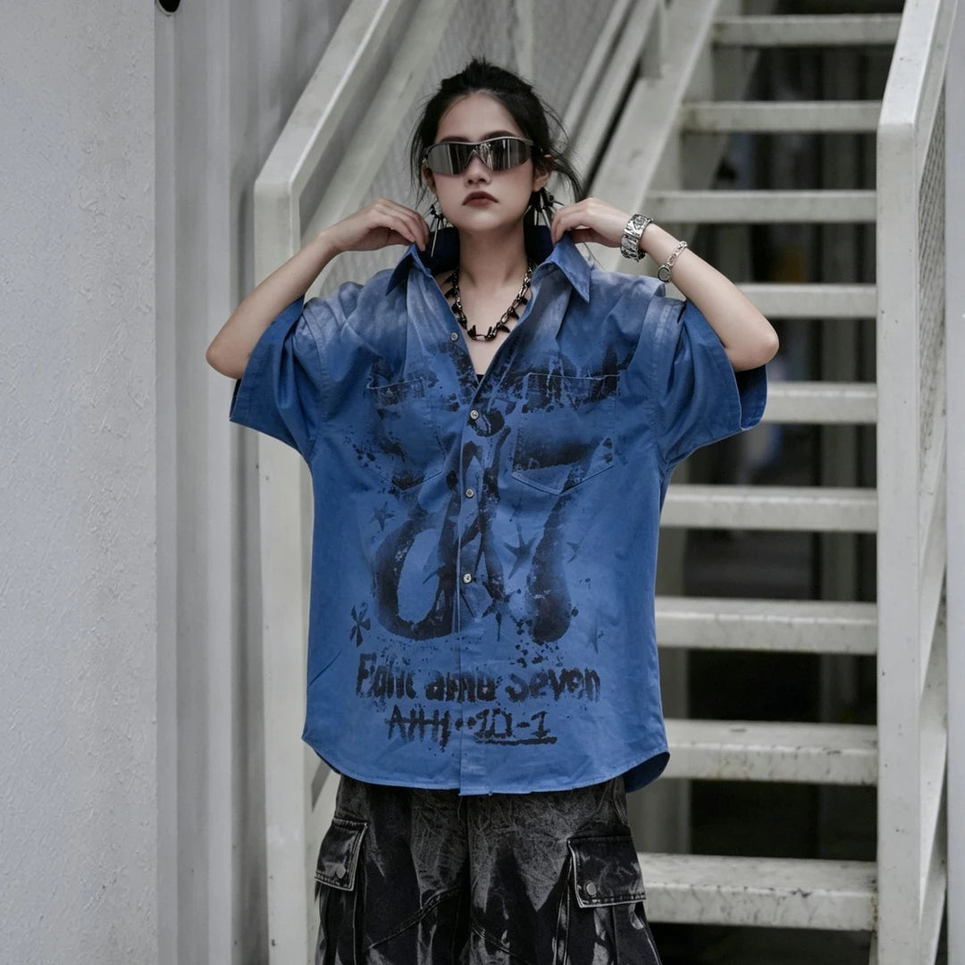 Sanhoostudio short sleeve shirt featuring graffiti print, distressed finish, and relaxed fit silhouette. Designed for modern streetwear styling with breathable fabric and versatile everyday wear.