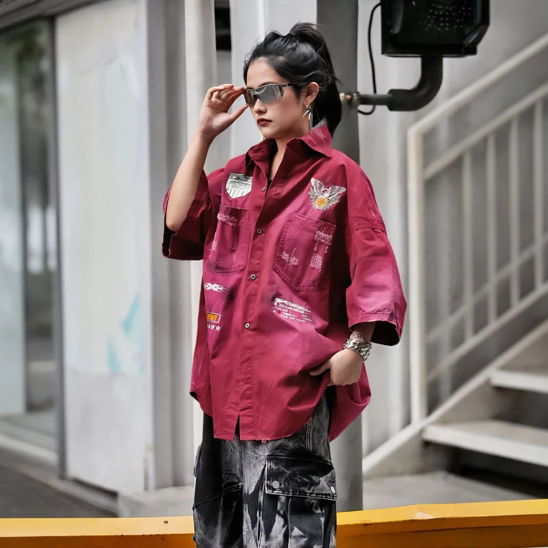 Sanhoostudio short sleeve shirt featuring military-inspired graphics, distressed dye finish, and relaxed silhouette. Designed for streetwear styling with breathable fabric and versatile daily wear.