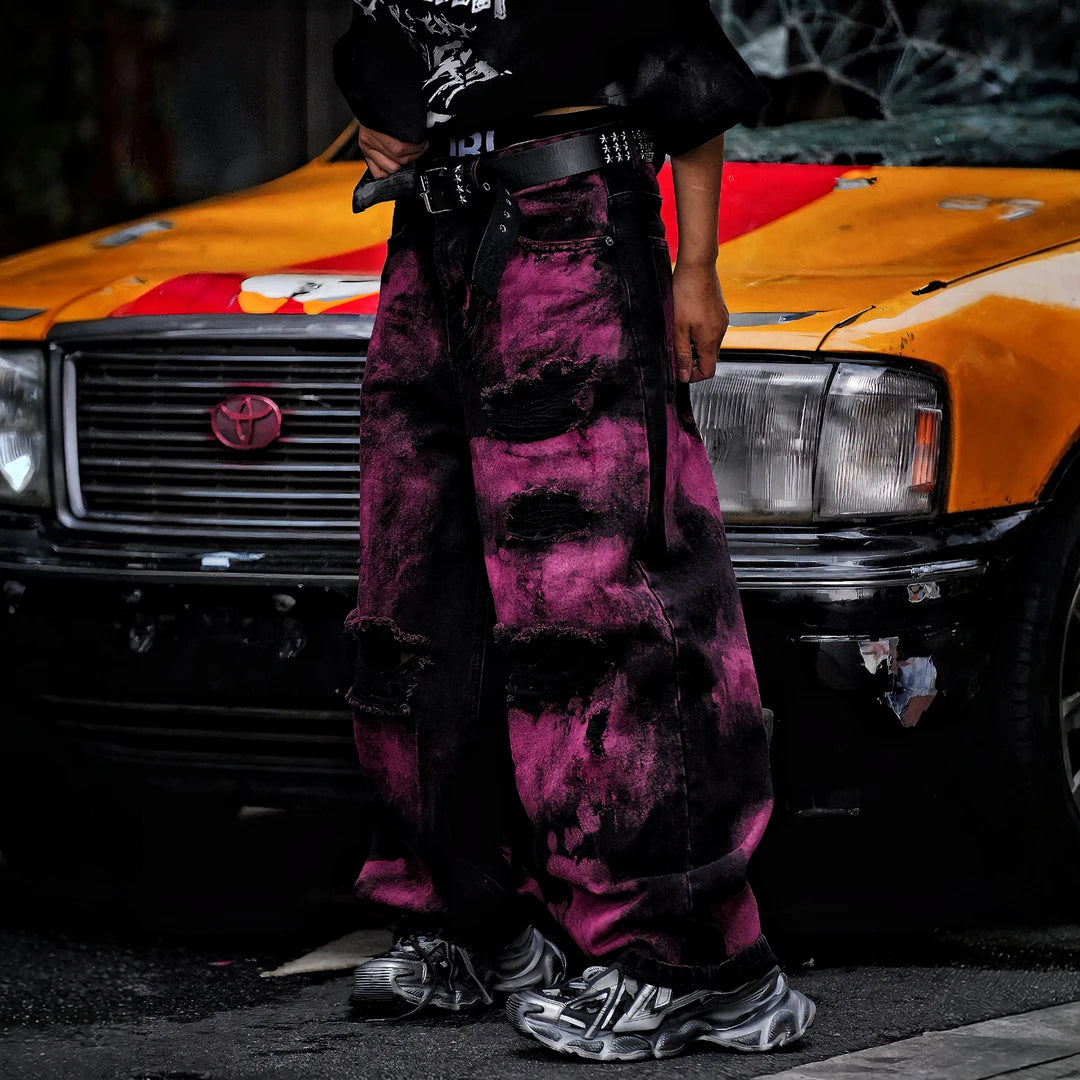 Sanhoostudio wide leg denim pants featuring embroidered detailing, distressed wash, and scythe-cut silhouette. Designed for bold streetwear styling with durability, comfort, and everyday versatility.