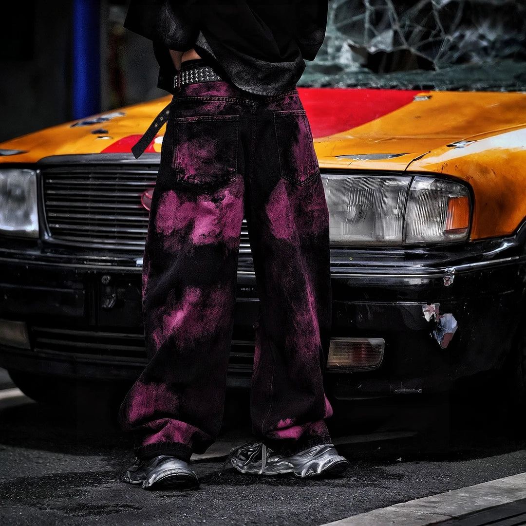 Sanhoostudio wide leg denim pants featuring embroidered detailing, distressed wash, and scythe-cut silhouette. Designed for bold streetwear styling with durability, comfort, and everyday versatility.