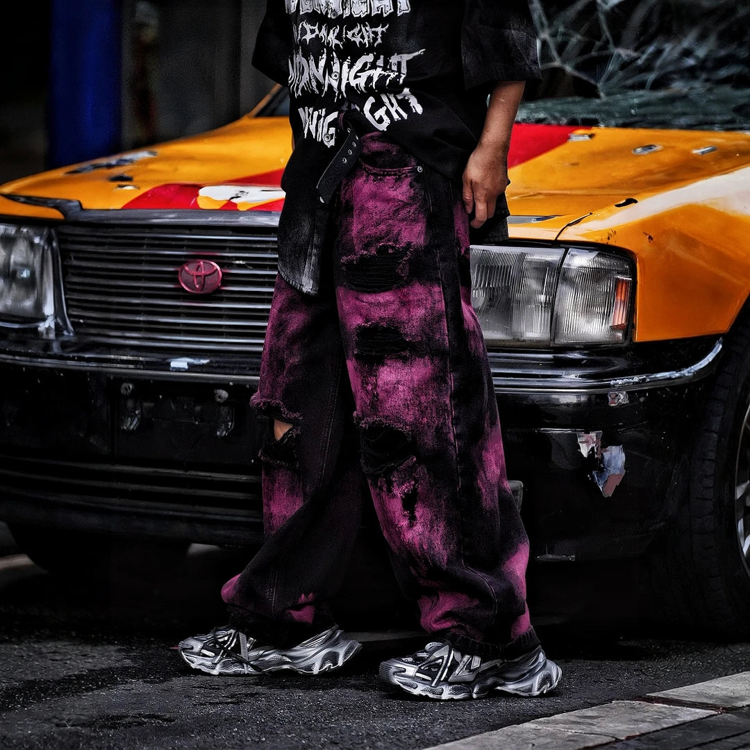 Sanhoostudio wide leg denim pants featuring embroidered detailing, distressed wash, and scythe-cut silhouette. Designed for bold streetwear styling with durability, comfort, and everyday versatility.