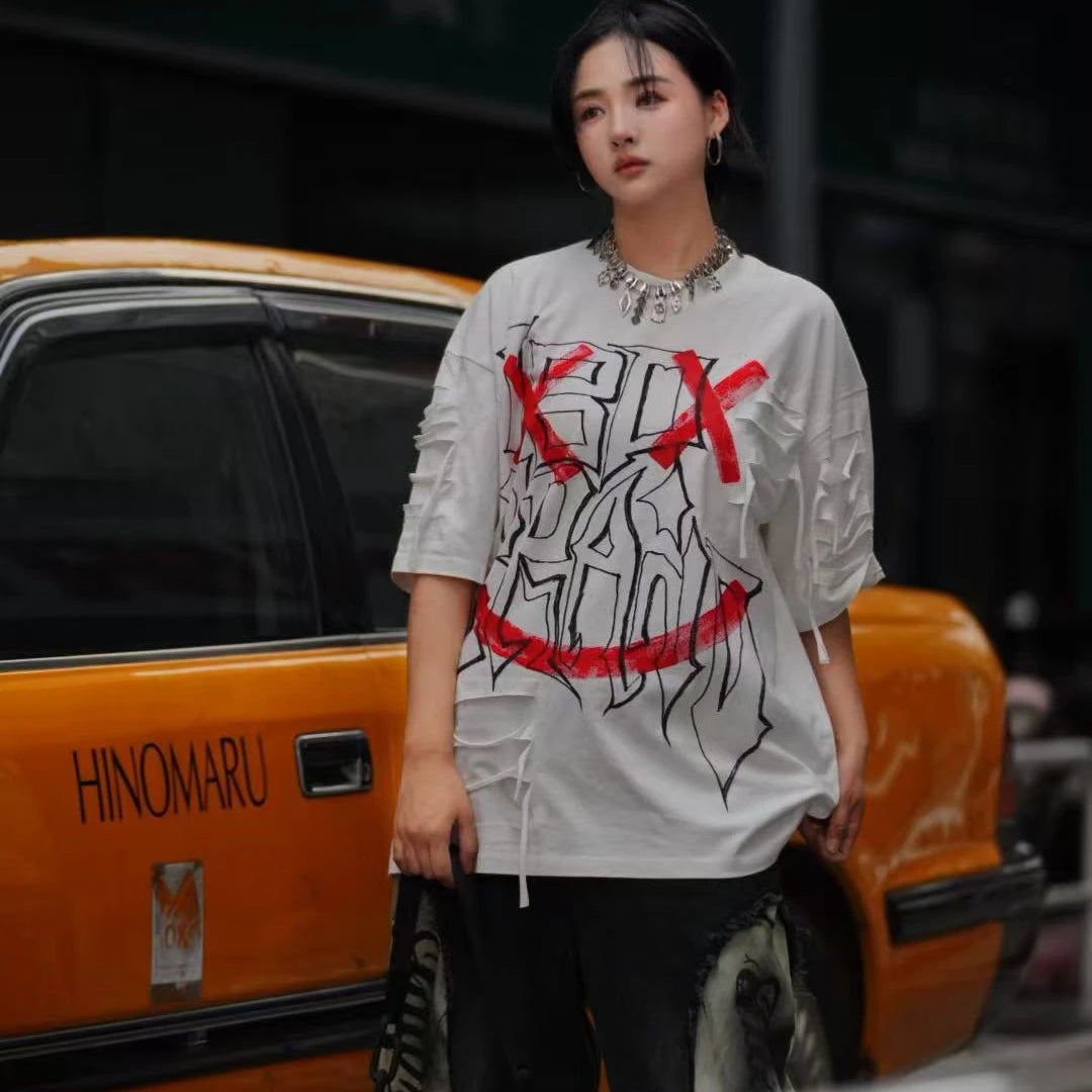 Sanhoostudio short sleeve T-shirt featuring graffiti print, tie dye finish, and patchwork design with an oversized fit silhouette. Designed for bold streetwear styling with breathable comfort, soft fabric feel, and versatile everyday wear for summer outfits.