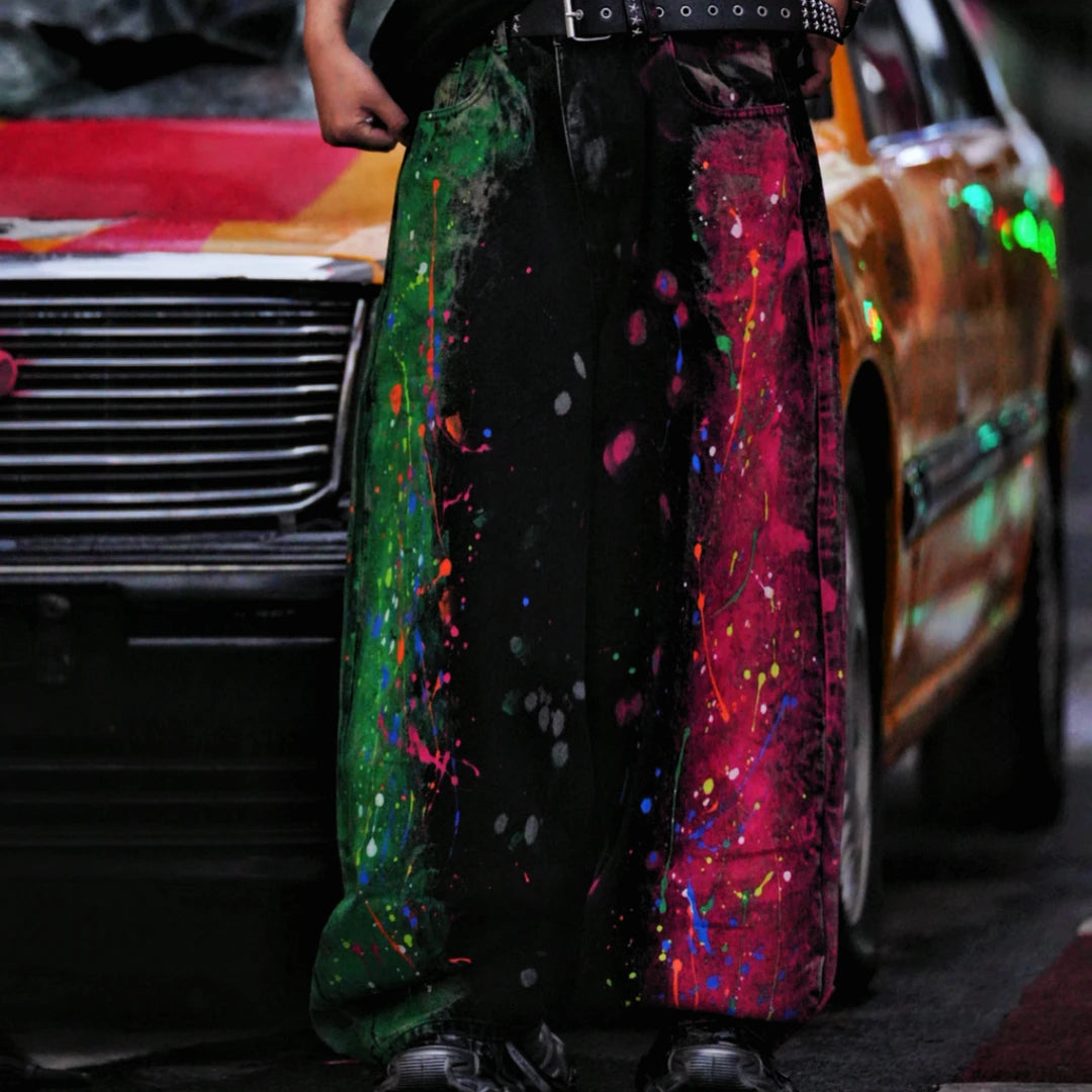 Sanhoostudio denim pants featuring graffiti artwork, patchwork construction, and distressed wash finish. Designed with a wide leg silhouette for bold streetwear styling with durability and comfort.