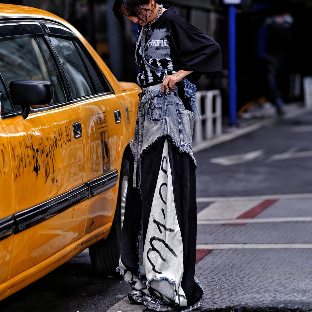 Sanhoostudio denim pants featuring distressed washed finish, patchwork detailing, and wide leg scythe-cut silhouette. Designed for modern streetwear styling with relaxed comfort and versatile everyday wear.