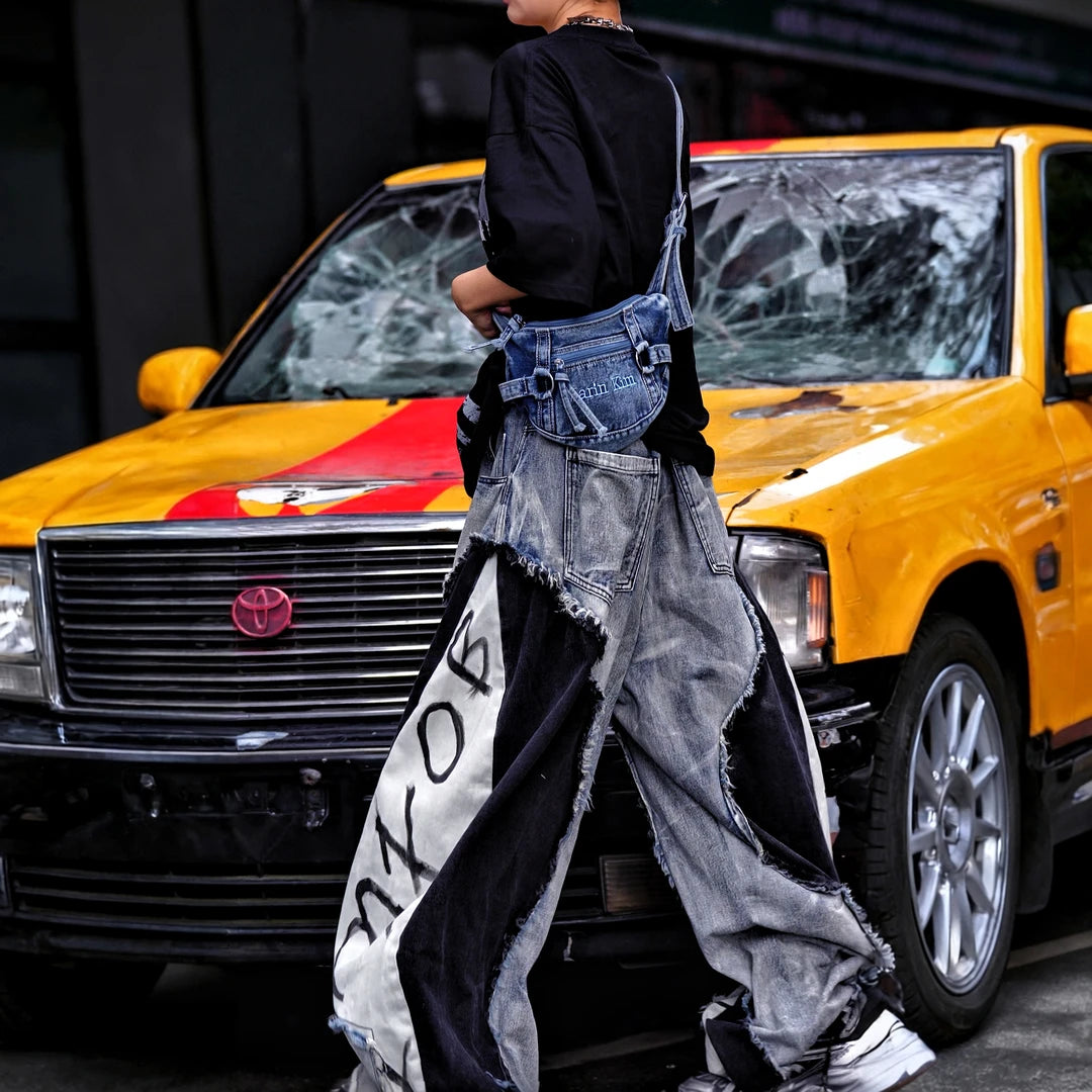Sanhoostudio denim pants featuring distressed washed finish, patchwork detailing, and wide leg scythe-cut silhouette. Designed for modern streetwear styling with relaxed comfort and versatile everyday wear.