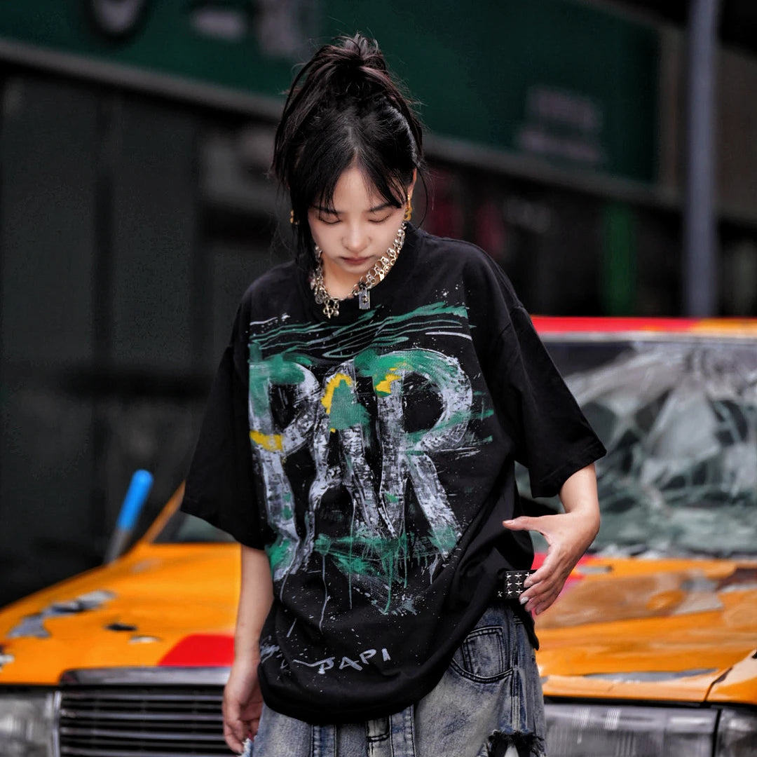 Sanhoostudio short sleeve T-shirt featuring graffiti spray print design and oversized fit silhouette. Designed for modern streetwear styling with breathable comfort, lightweight feel, and versatile everyday summer wear.