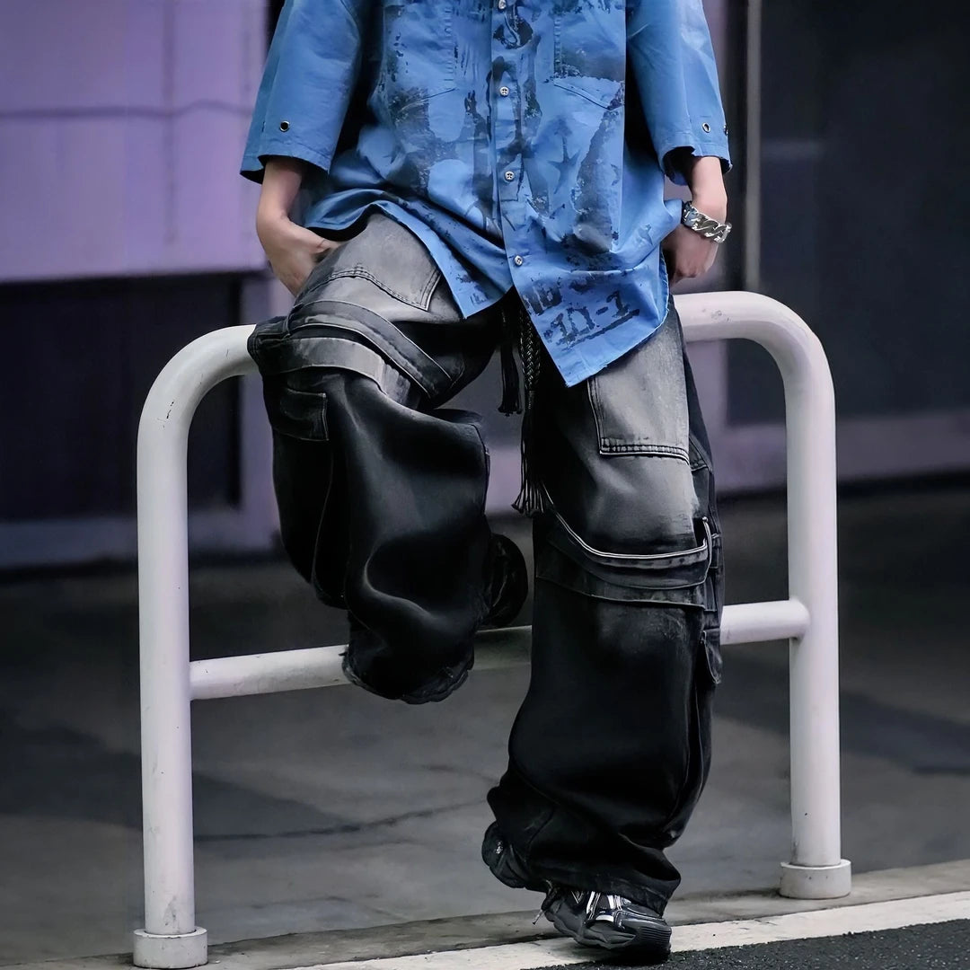 Sanhoostudio denim pants featuring colorblock patchwork construction, cargo-inspired details, distressed wash finish, and a wide leg scythe-cut silhouette. Designed for bold streetwear styling with comfort and versatility.