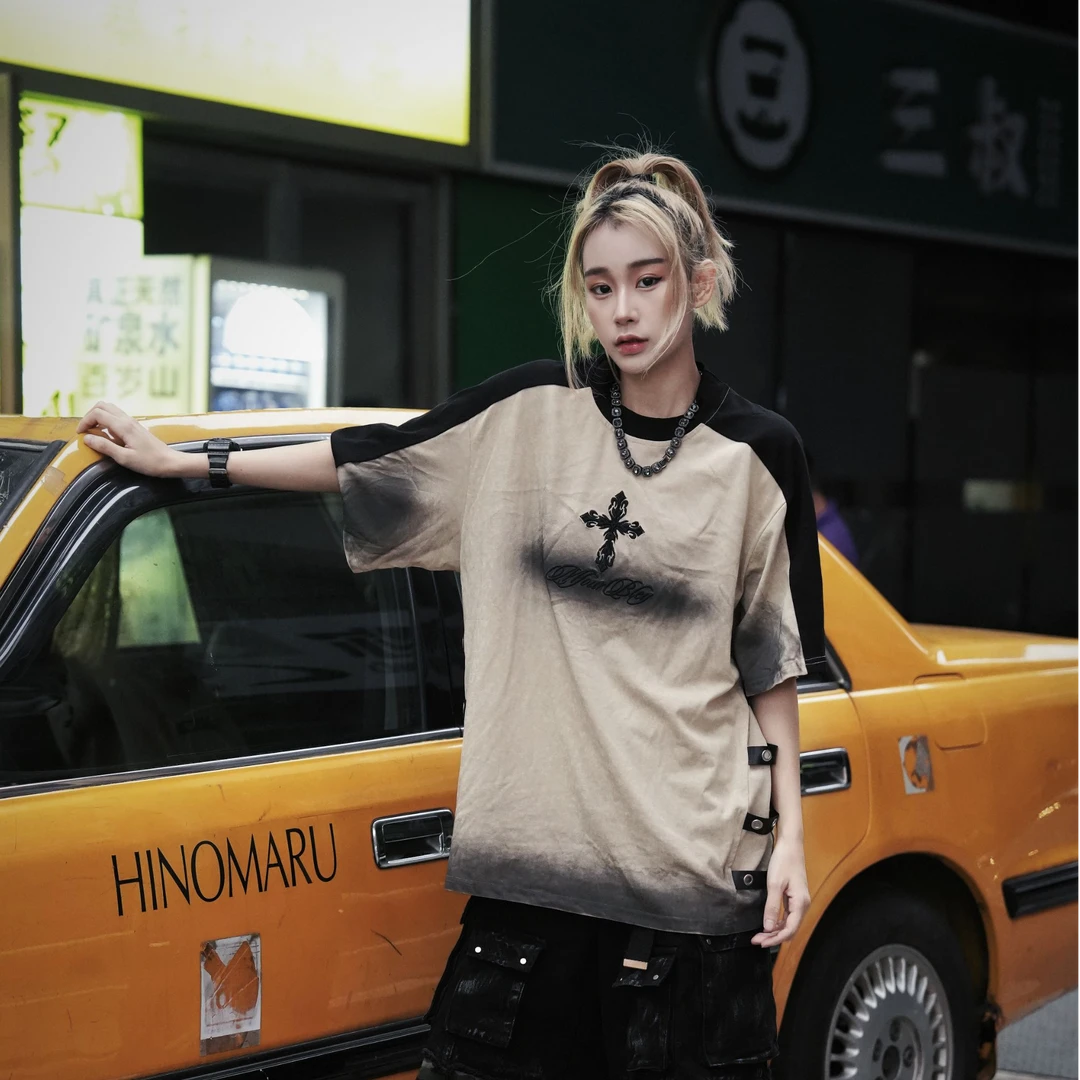 Sanhoostudio short sleeve T-shirt featuring cross embroidery, spray print artwork, and distressed detailing. Designed for dark streetwear styling with a relaxed fit and standout visual character.