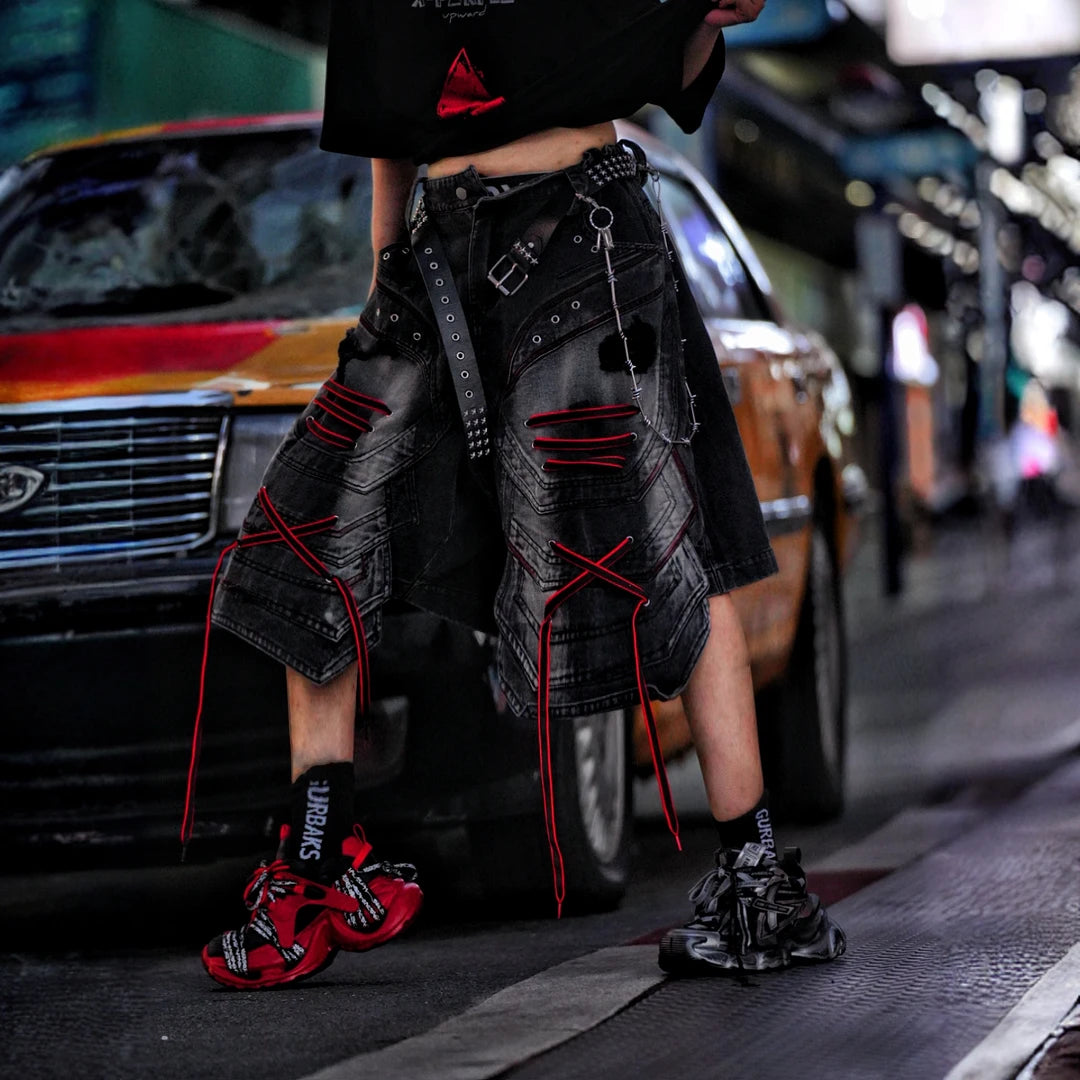 Sanhoostudio denim shorts featuring distressed wash treatment, patchwork construction, and an irregular loose-fit silhouette. Designed for summer streetwear styling with breathable comfort and standout urban appeal.