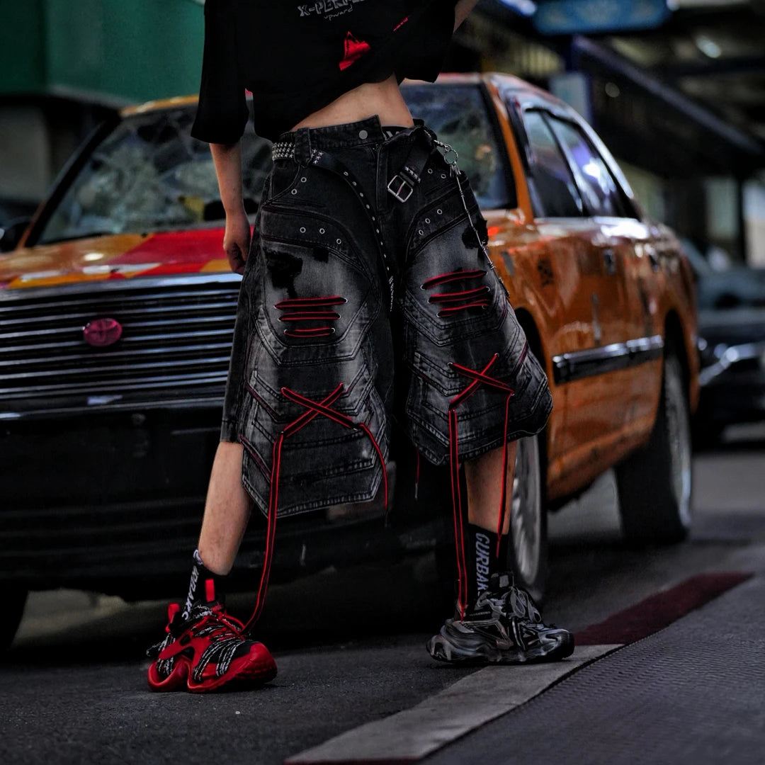 Sanhoostudio denim shorts featuring distressed wash treatment, patchwork construction, and an irregular loose-fit silhouette. Designed for summer streetwear styling with breathable comfort and standout urban appeal.