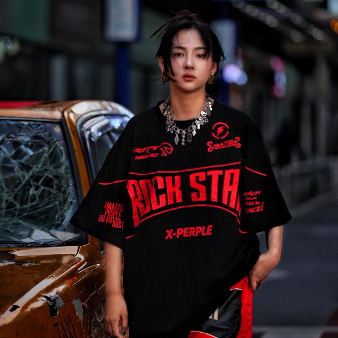 Sanhoostudio short sleeve T-shirt featuring flame-inspired graphic artwork, spray print detailing, and a relaxed oversized silhouette. Designed for modern streetwear styling with breathable comfort and visual impact.