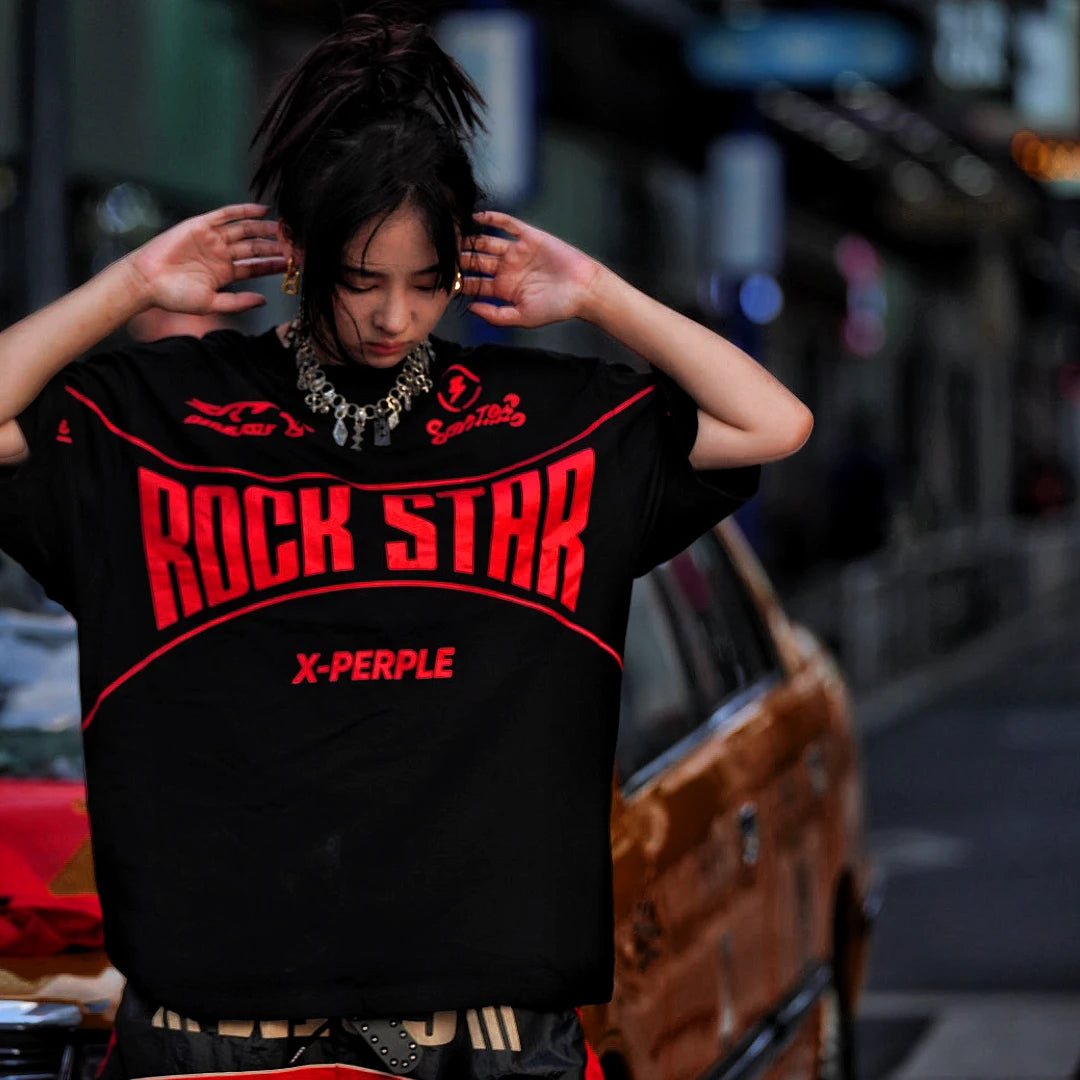 Sanhoostudio short sleeve T-shirt featuring flame-inspired graphic artwork, spray print detailing, and a relaxed oversized silhouette. Designed for modern streetwear styling with breathable comfort and visual impact.