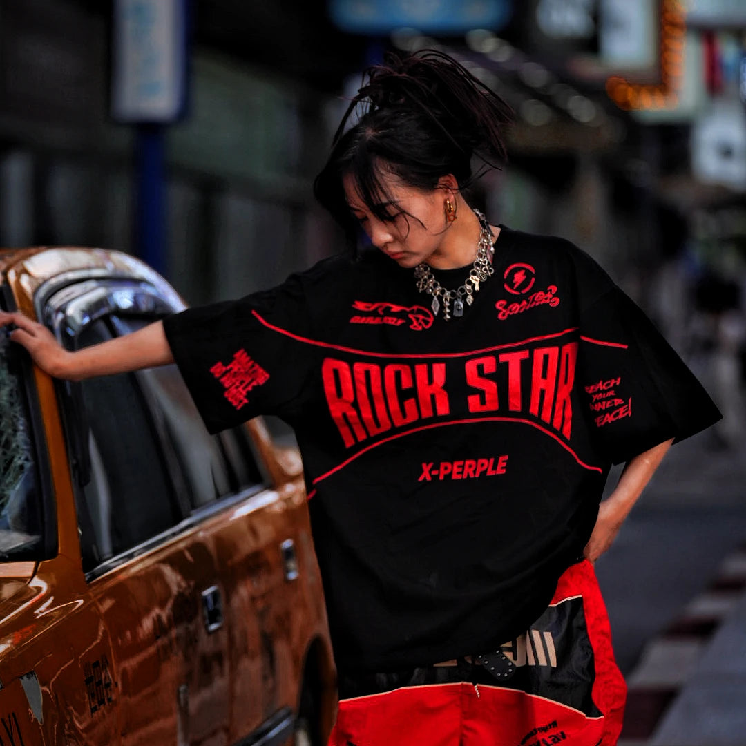 Sanhoostudio short sleeve T-shirt featuring flame-inspired graphic artwork, spray print detailing, and a relaxed oversized silhouette. Designed for modern streetwear styling with breathable comfort and visual impact.