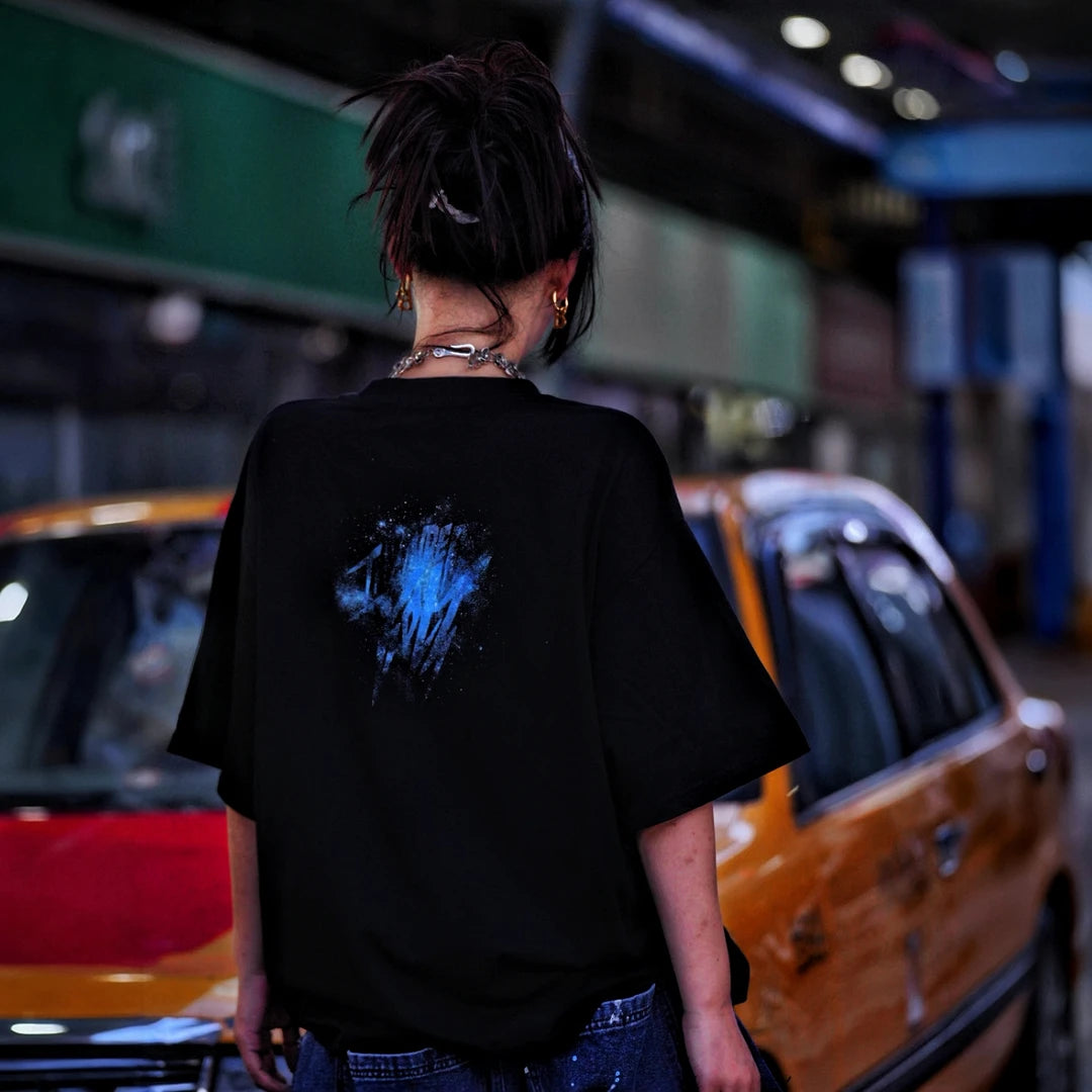 Sanhoostudio short sleeve T-shirt featuring galaxy-inspired graphic artwork, breathable fabric, and a relaxed oversized fit. Perfect for summer streetwear styling with comfort, creativity, and everyday wearability.