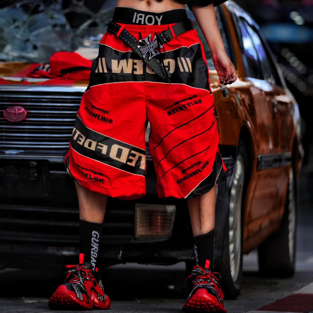 Sanhoostudio wide leg pants featuring detachable styling elements, racing-inspired panel construction, and a relaxed fit. Designed for modern streetwear outfits with comfort, versatility, and bold visual appeal.