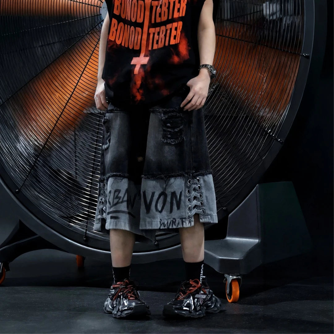 Sanhoostudio sleeveless T-shirt featuring distressed detailing, red spray-print artwork, and a relaxed oversized fit. Designed for summer streetwear styling with breathable comfort and a bold urban aesthetic.