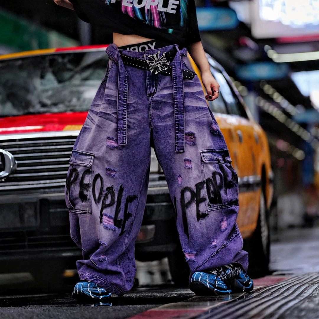 Sanhoostudio denim pants featuring distressed wash treatment, patchwork details, and a wide leg scythe-cut silhouette. Designed for modern streetwear styling with relaxed comfort and premium visual character.