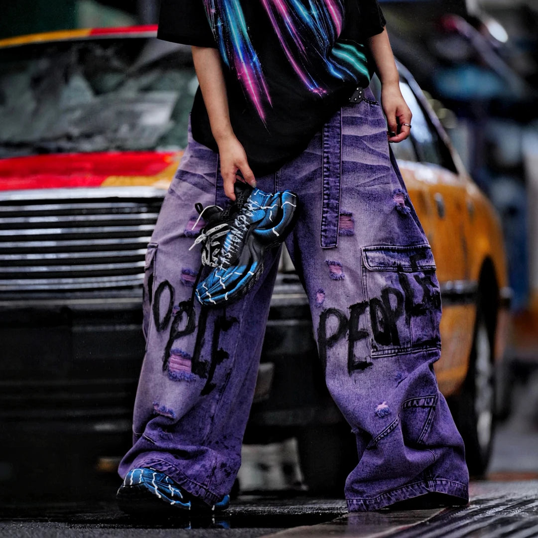 Sanhoostudio denim pants featuring distressed wash treatment, patchwork details, and a wide leg scythe-cut silhouette. Designed for modern streetwear styling with relaxed comfort and premium visual character.