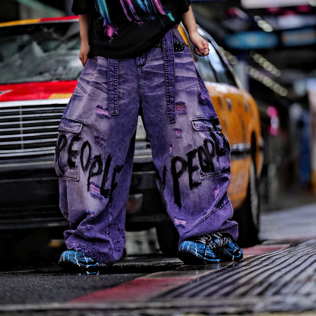 Sanhoostudio denim pants featuring distressed wash treatment, patchwork details, and a wide leg scythe-cut silhouette. Designed for modern streetwear styling with relaxed comfort and premium visual character.