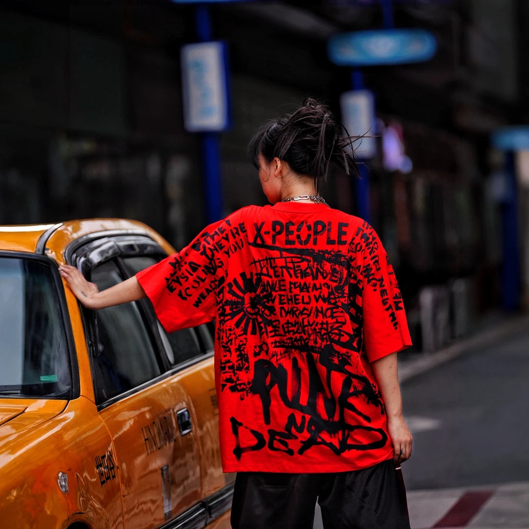 Sanhoostudio short sleeve T-shirt featuring spray-print artwork, breathable fabric construction, and an oversized fit silhouette. Designed for modern streetwear styling with comfort and standout summer appeal.