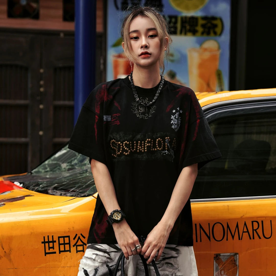 Sanhoostudio jersey-inspired short sleeve T-shirt featuring flame graphics, studded details, and a loose oversized fit. Built for retro streetwear outfits with breathable comfort and standout visual appeal.