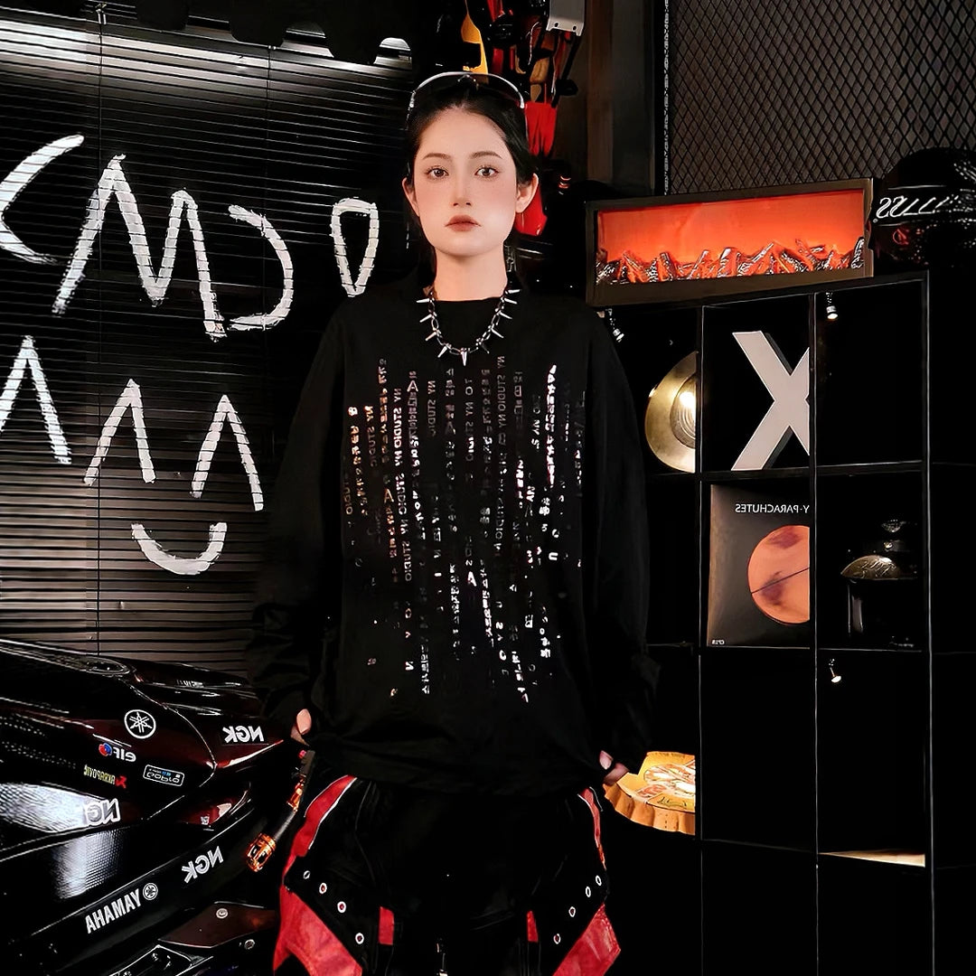 Sanhoostudio long sleeve T-shirt featuring reflective letter graphics and a relaxed oversized silhouette. Designed for dark streetwear and high-street styling, this statement top delivers comfortable everyday wear with eye-catching reflective details and an effortless layered look.